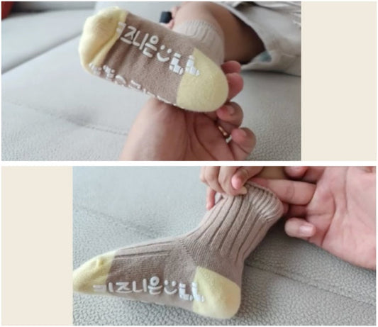 Mum putting non-slip right-angle socks on toddler