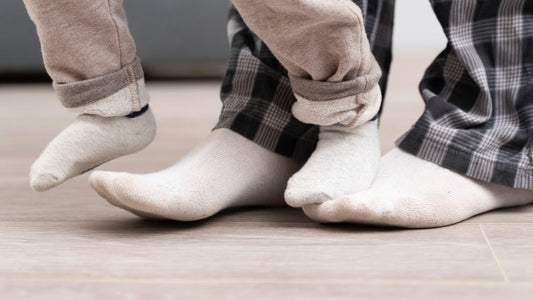 Dad playing together with kids wearing right-angle socks